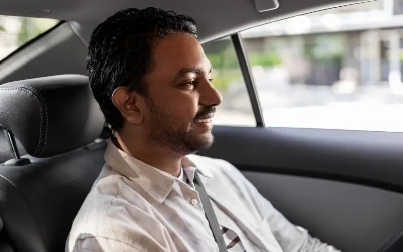 Passenger enjoying comfortable ride in Dehradun Airport to Mussoorie taxi inside clean cab