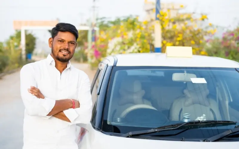 Professional taxi driver standing with car for Dehradun Airport to Mussoorie taxi service
