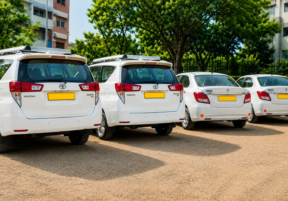 White commercial taxi cars lined up for airport pickup in this Jolly Grant Airport (Dehradun) guide.