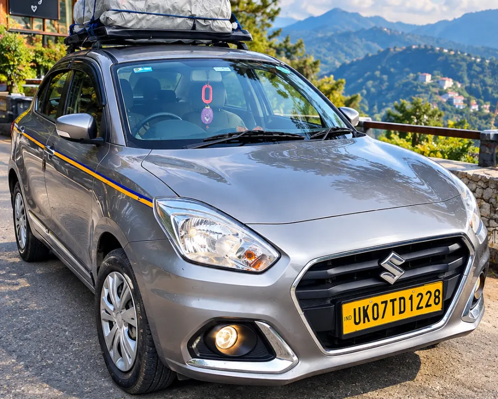 Grey Maruti Swift Dzire sedan cab with luggage carrier for Dehradun Airport to Chardham Yatra taxi service